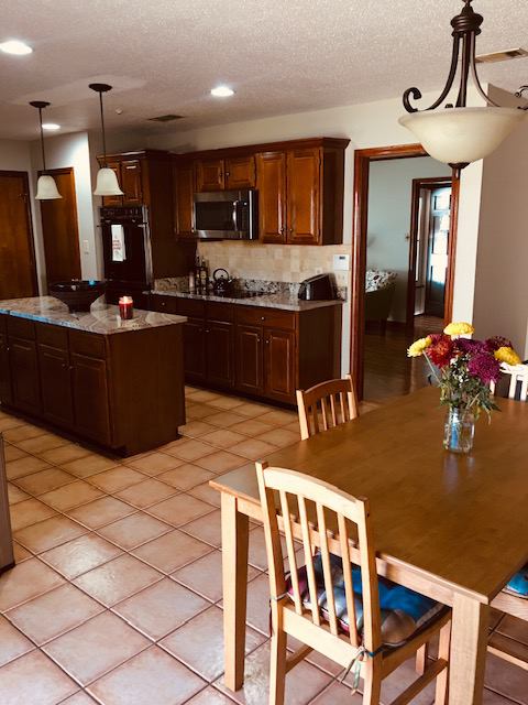 Photo 1: FULL EQUIPPED KITCHEN with coffee pot, toaster, microwave & dish wear