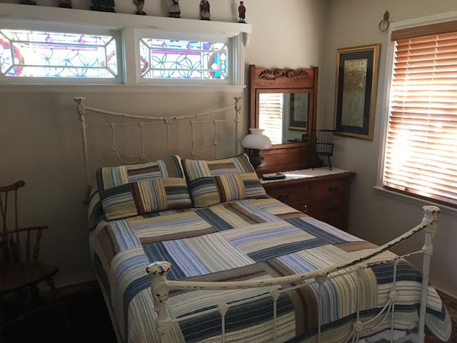 Photo 1: Antique double bed in cozy bedroom