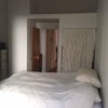 Photo 2: Bedroom w/ closet curtain + storage above