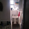 Photo 7: Bathroom with storage shelves.