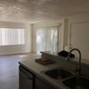 Photo 1: View of the living room and front door from the kitchen