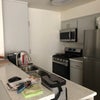Photo 5: Photo looking into the kitchen from the counter