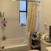 Photo 5: Bathroom (curtain pulled to show tub)