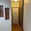 Photo 3: front door + bathroom parallel to brick wall