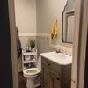 Photo 9: Shared bathroom. Updated appliences/tub in 2022. Shelving behind door available for personal items. 