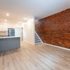 Photo 5: Shared living space with exposed brick