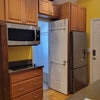 Photo 6: Cook top, Convection oven, Microwave, Fridge, and bathroom door