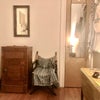 Photo 6: The other side of the bedroom, w/ full closet, mirror, hooks.. Chair and vintage ice-box w/ storage 