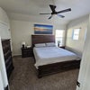 Photo 6: Your bedroom, Cali King bed with 65" TV, armoire, dresser, chest 2nd tall dresser, under bed storage