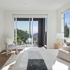 Photo 7: Spacious bedroom with sliding glass door access to private balcony