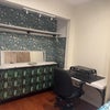 Photo 1: Table, dresser and open clothes closet 