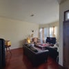 Photo 7: Living Room w/ additional food pantry storage on left