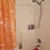 Photo 6: Yor full bathroom with bright finishes and shower/tub combo — all yours, just outside the bedr