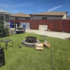 Photo 6: Back yard fire pit and movie area. Parking next to side of house