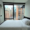 Photo 6: Private Bedroom with a bed, a nightstand, a walk-in closet, and a landmark Chicago view