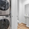 Photo 4: In-unit washer and dryer with convenient half bath