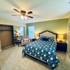Photo 2: Furnished master bedroom with queen bed