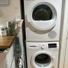 Photo 3: Bosch 300 Series washer/dryer, provided laundry items, clothing steamer, handheld vacuum, iron, and 
