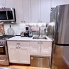 Photo 8: Chef’s kitchen with gas range/oven, DeLonghi espresso machine and burr grinder, dishwasher, toaste