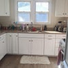Photo 8: Freshly painted kitchen and new flooring leading into laundry room w a brand new washer