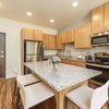 Photo 3: Kitchen and shared living space (typical StonePointe interior)