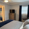 Photo 2: Private queen bedroom with smart TV and open en-suite bathroom