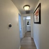 Photo 4: Hallway coming from the room going to the bathroom. Other room is the door on the left and is connec