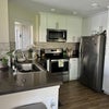 Photo 7: Kitchen includes stainless steel appliances + airfryer, tea kettle, nutribullet, and toaster.