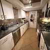 Photo 6: Galley kitchen with gas stovetop, dishwasher, double sink, microwave and fridge