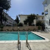 Photo 9: Large quiet swimming pool with deck chairs and outdoor dining table