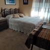 Photo 2: Furnished room with brass headadboard