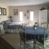Photo 1: Queen bed, table and chairs, TV with DVD's in corner unit