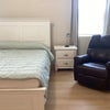 Photo 3: recliner and nightstand by bed