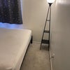 Photo 2: Queensize bed with lamp that has small shelves for alarm clock and to charge your cell. 