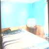 Photo 3: the room showing bed and fan on table