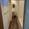 Photo 4: Tub and shower. New paint, flooring and shelving.