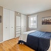 Photo 6: Taken from the Apartments listing. There is carpet and no paint on wooden drawers with built in shel