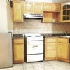Photo 5: Kitchen area ( stove is grey and fridge is full sized and grey