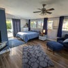 Photo 2: Spacious furnished private room with queen bed, sitting area, TV, and good natural light.