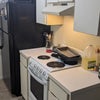 Photo 4: Refrigerator, microwave, oven, and cooktop in kitchen