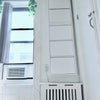 Photo 6: Air conditioner in the room, large wall mounted shoes container behind the door