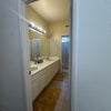 Photo 9: spacious bathroom with 2 sinks, drawers, storage for toiletries; 2nd door in front of toilet/shower.