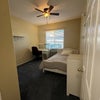 Photo 6: Bedroom #2 with mirrored closet, furnished with bed, bedding, desk, chair, shelves, ceiling fan.