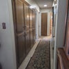 Photo 3: The hallway. The room is the last door on the left