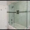 Photo 5: Sleek walk-in shower with glass enclosure