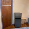 Photo 4: Refrigerator, small table and towel rack. 