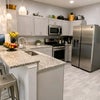 Photo 4: Fully equipped shared kitchen with ample cabinet space.