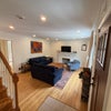 Photo 2: Living room. Working fireplace. Bedroom behind decorated wall.