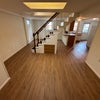 Photo 8: basement. kitchen with oven, range, microwave, sink, fridge. laundry attached. bed room to right