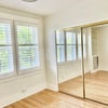 Photo 3: mirror-covered closet runs full length of room 